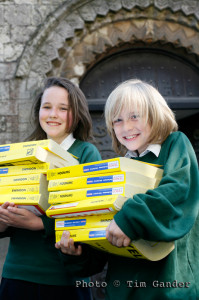 children carrying yellow pages