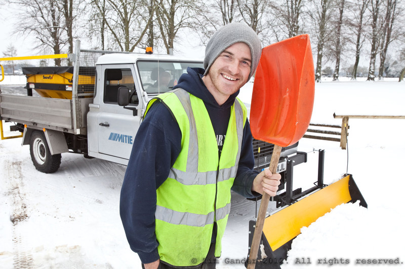 Snowplough operative with truck and shovel