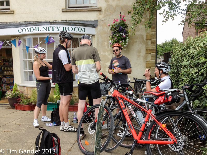 Cyclists at a village shop taking a refreshment break