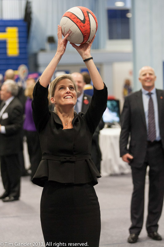 Sophie Wessex smiles as she holds a netball aloft and aims to take a shot at the net