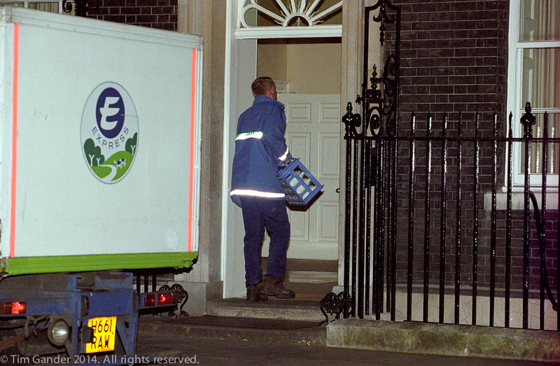 A milkman delivers a crate of milk to 10 Downing Street, London