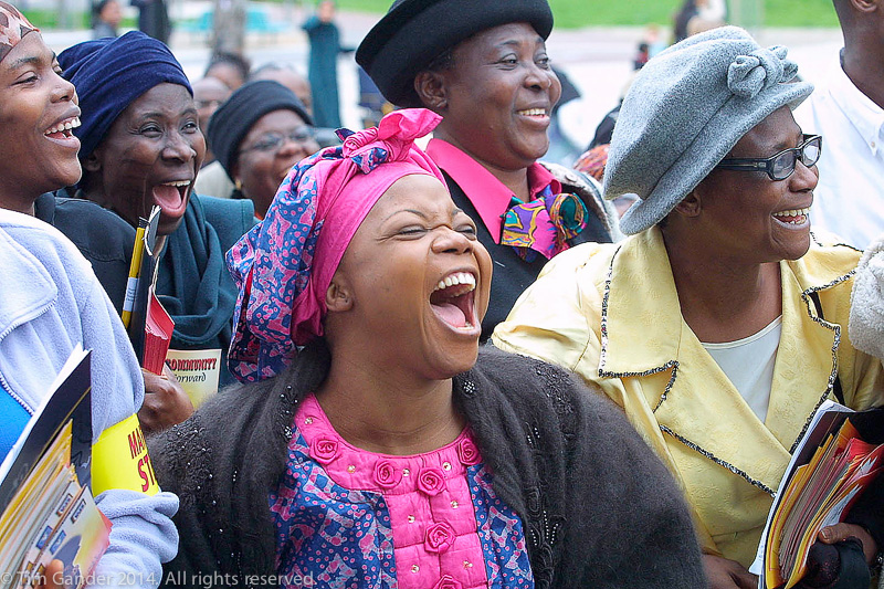 A group of black ladies laugh heartily at the end of a march in honour of murdered teenager Damilola taylor