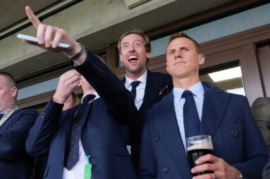 Former England footballer Peter Crouch reacts with joy as his horse comes in at Cheltenham Races.