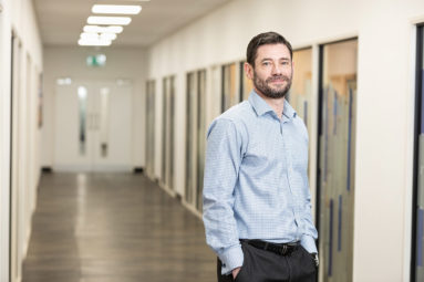 CEO Paul Hill of Hamberley Care Homes poses in a corridor.