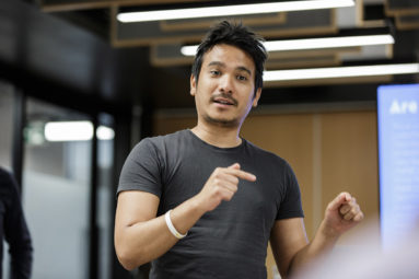 An entrepreneur stands and talks in a seminar.