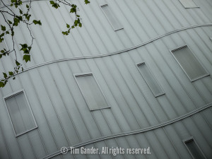 Architectural detail of a grey building in London with wavy walls