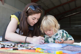 07/06/2015 Hosted at Meadowlea Farm in Compton Durville, Somerset, ABP Food Group staff get stuck in with Open Farm Sunday to help members of the public understand where their food comes from and how it's produced. Robyn Smyth of ABP helps young visitor Tom with a bit of colouring in. © Tim Gander 2015. All rights reserved.