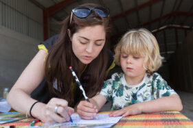 07/06/2015 Hosted at Meadowlea Farm in Compton Durville, Somerset, ABP Food Group staff get stuck in with Open Farm Sunday to help members of the public understand where their food comes from and how it's produced. Robyn Smyth of ABP helps young visitor Tom with a bit of colouring in. © Tim Gander 2015. All rights reserved.