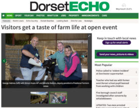 Screen grab from The Dorset Echo which shows farmer George Holmes feeding a calf with MP Simon Hoare and Minette Batters of the National Farmers Union