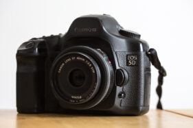 Canon 5D original or MKI camera body with a 40mm f/2.8 pancake lens attached.