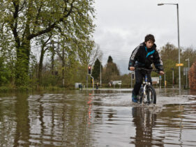 A boy cycles carefully through Frome floodwater in 2011.