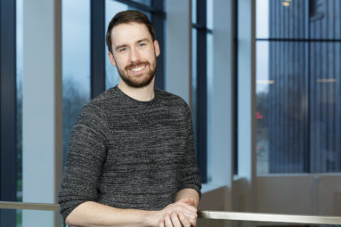 Kenny Cunniffe for University of Bath pictured with part of the interior of the Chancellors Building in the background.