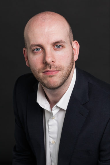 Headshot of Matt Leipnik of Digital Catapult, London non-smiling, against black.