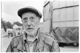 Geoff, aged 64, portrait taken in the old cattle market in Frome, Somerset with the funfair in the background.