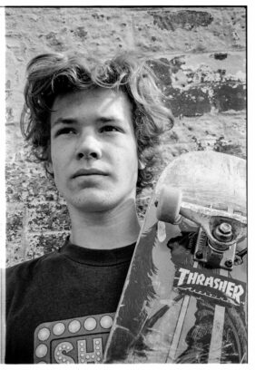 Ben Charlesworth poses with his skateboard outside the Cheese and Grain in Frome, Somerset, UK.