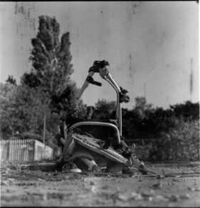 A wrecked push chair resembles a broken robot.