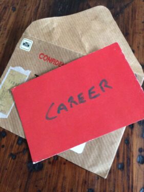 Red card with the word "CAREER" handwritten in capital letters on the front.