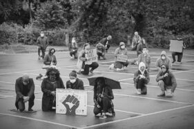 Groups of people and individuals take the knee in Frome's Cheese and Grain car park in honour of George Floyd who was killed by police two weeks ago in the US.