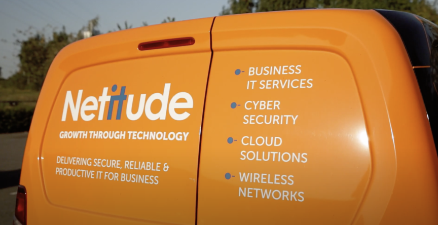 Still from Netitude video showing the rear door text of a Netitude van.