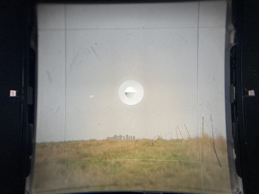 The view of an image of Stonehange as seen on the focusing screen of a medium format camera.