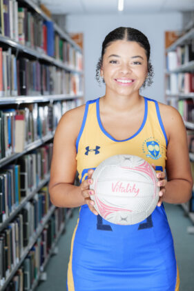 single portrait of netball player Jemma Nightingale in a university library