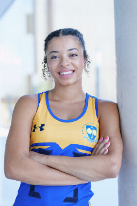 Portrait of a smiling female netball player looking to camera