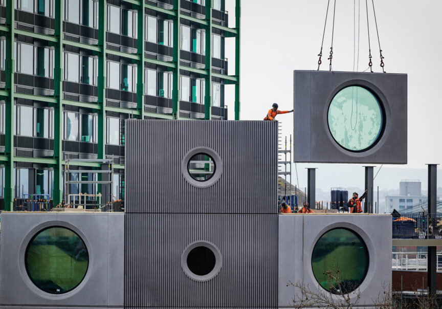 A pre-cast section of Building C is craned into place during the construction of Assembly Bristol in Bristol, UK.