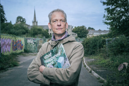 Outdoor photographer self portrait of Tim Gander holding his book What Happened Here