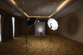 A three-head studio portrait set-up in a hotel ballroom.