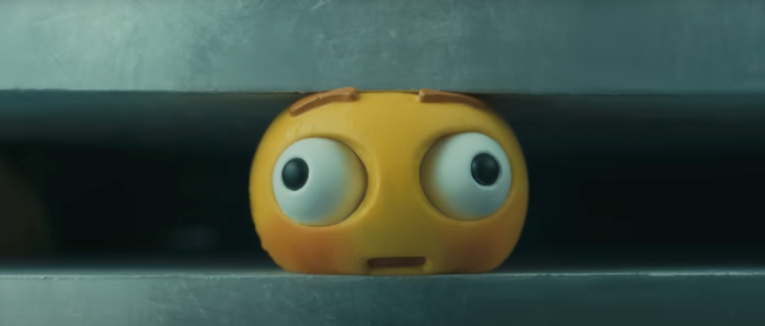 A video grab from Apple's latest iPad advertisement shows the alarmed expression on a squishy toy's face just before it is crushed by a machine.